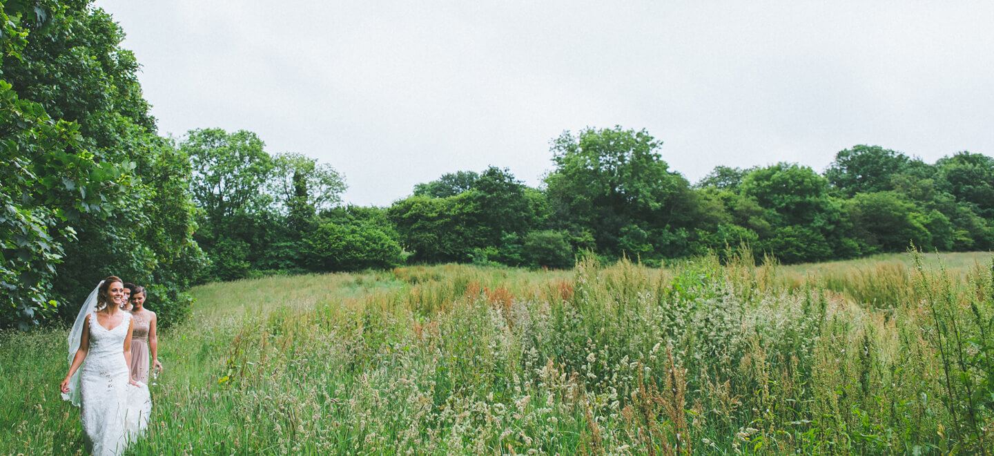 Brides Walking Through Meadow At Kilminorth Cottages Diy Wedding Venue Cornwall Gay Wedding Guide 1