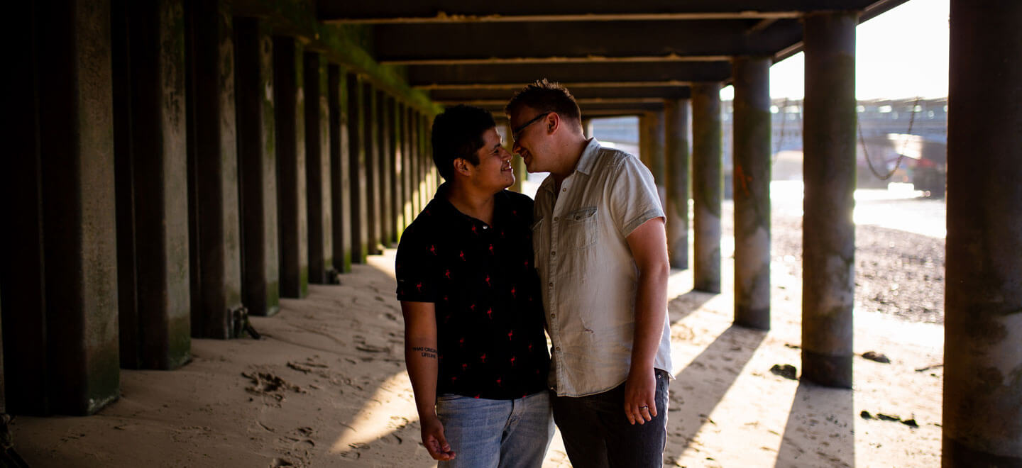 1440 Neill Iggy look at each other under bridge on Gay Engagement shoot on London Southbank image by Engagement Chapter via Gay Wedding Guide 1 4
