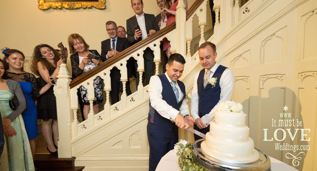 23 Neil and Rumen cut the cake image by It Must Be Love Weddings Photographer Hampshire via Real Gay Wedding on the Gay Wedding Guide 3 5