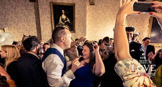 25 people dancing at Neil and Rumens wedding image by It Must Be Love Weddings Photographer Hampshire via Real Gay Wedding on the Gay Wedding Guide 3 5