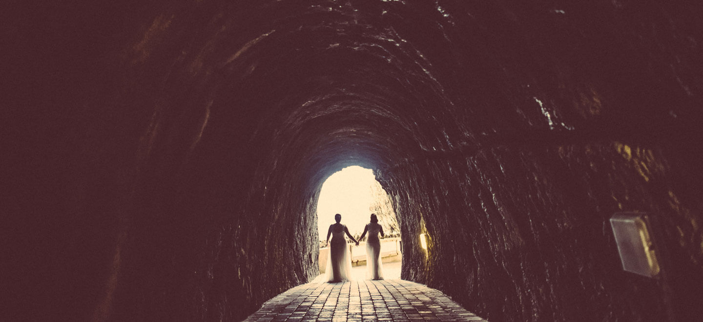 7 lesbian wedding brides walk out of cave image by gay wedding photographer GRW Photography7 6