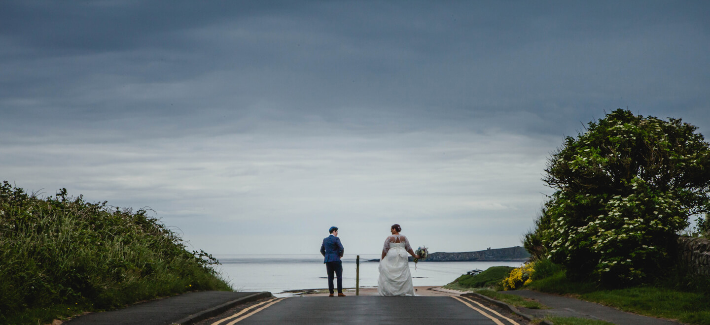 8 lesbian brides walk to edge of pier at lesbian wedding image by Newcastle wedding photographer Erica Tanith Photography via Gay Wedding Guide 6
