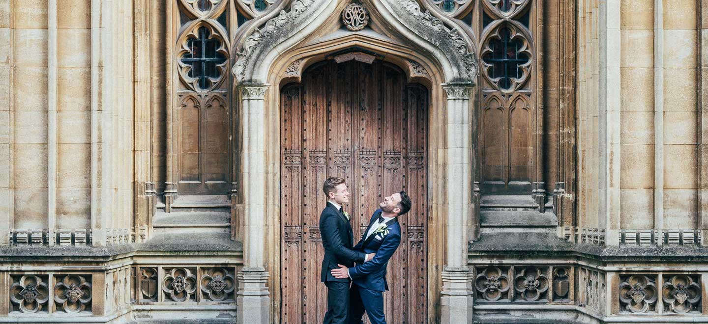 Aaron and Phil by door at their gay wedding at the Bodelian Oxford images copyright Stu Heppell via The Gay Wedding Guide 3 5