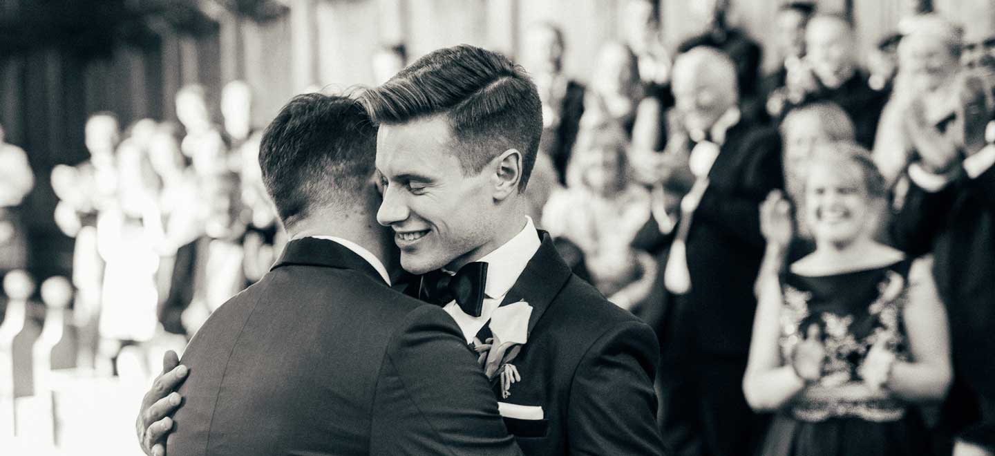 Aaron and Phil embrace at their gay wedding at the Bodelian Oxford images copyright Stu Heppell via The Gay Wedding Guide 3 5