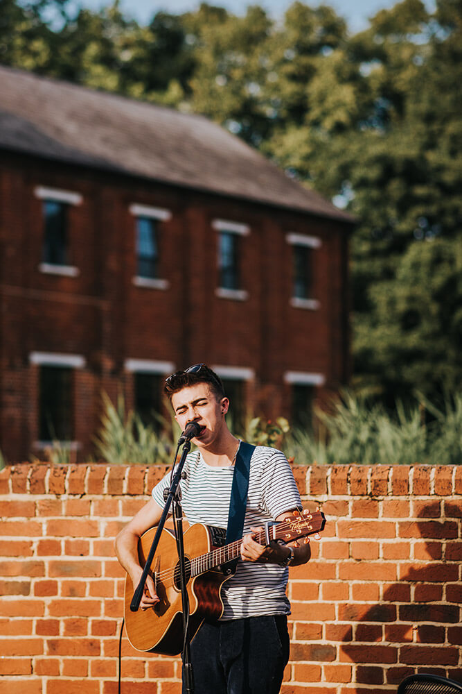 Acoustic singer at Lee and Simon Gay wedding at Bombay Sapphire Distillery Gay Wedding Guide image by This and That Photography 1 5