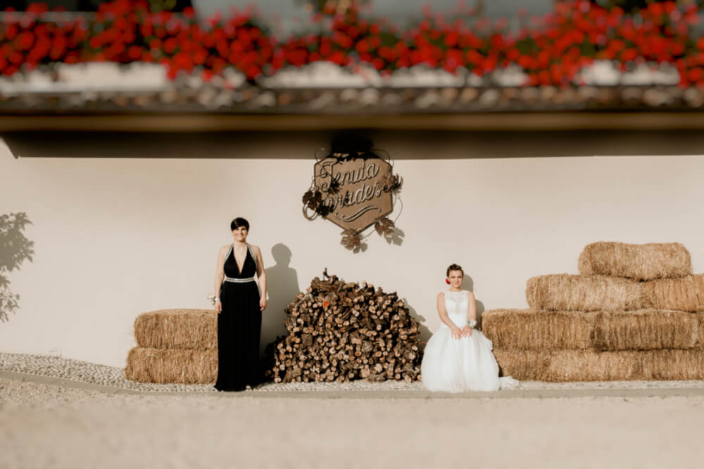Agnese and Gaia by hay bales at their lesbian wedding photography Frank Cattuci Photo via Gay Wedding Guide 1 5