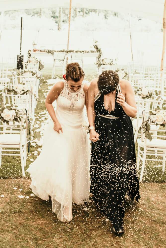 Agnese and Gaia walk under confetti at their lesbian wedding photography Frank Cattuci Photo via Gay Wedding Guide 1 5