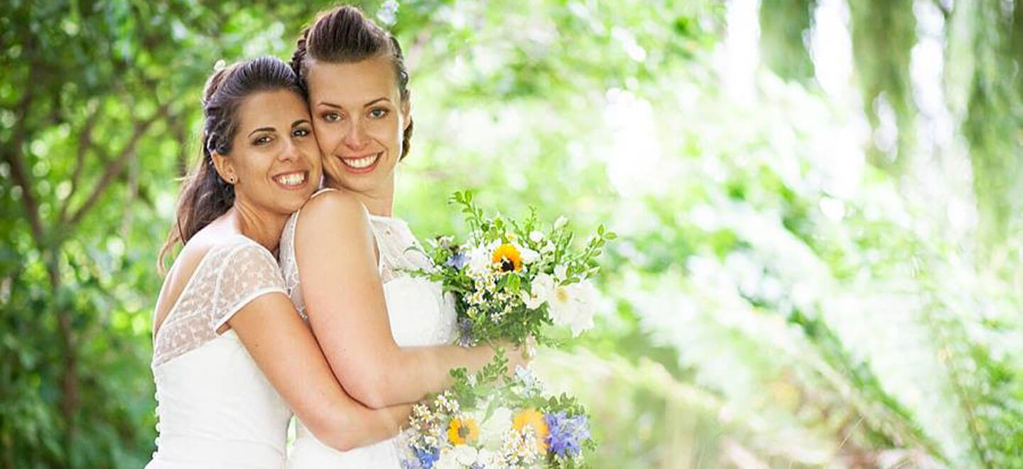 Ale and Eva real lesbian wedding brides cuddle image copyright Paola De Paola Photography via The Gay Wedding Guide 3 5