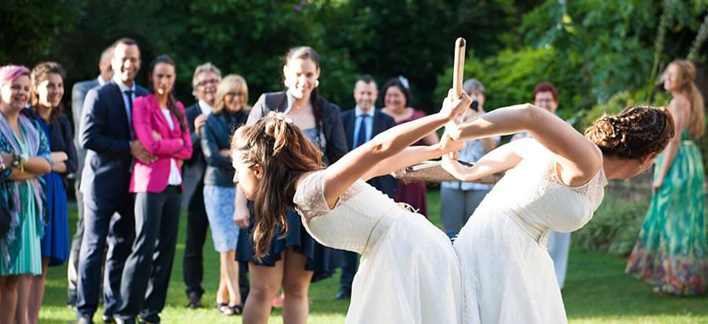 Ale and Eva real lesbian wedding broomstick challenge image copyright Paola De Paola Photography via The Gay Wedding Guide 3 5