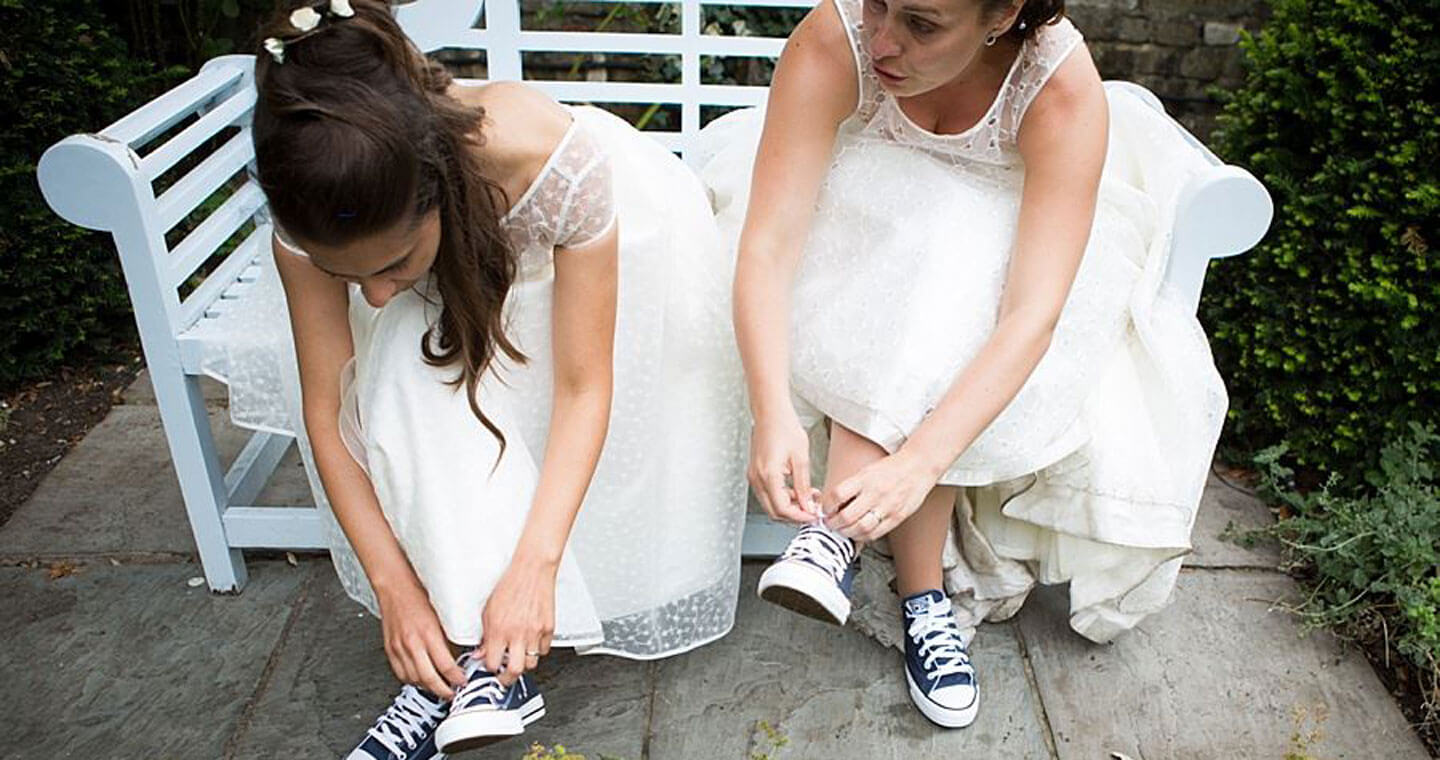 Ale and Eva real lesbian wedding putting on converse image copyright Paola De Paola Photography via The Gay Wedding Guide 3 5