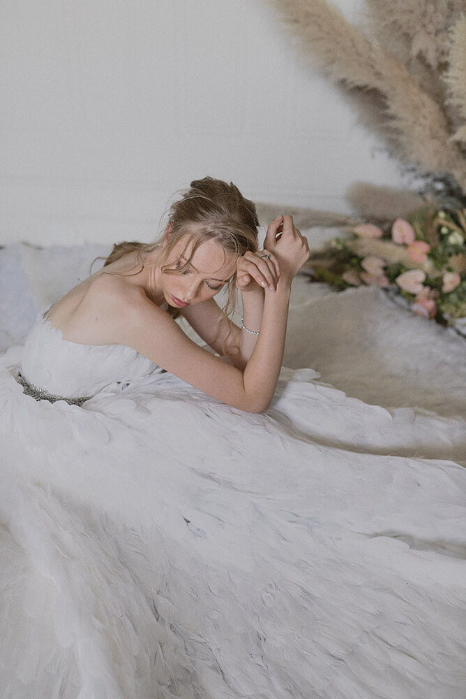 Ballerina sits in white dress at Swan Lake wedding shoot styled via Gay Wedding Guide 8