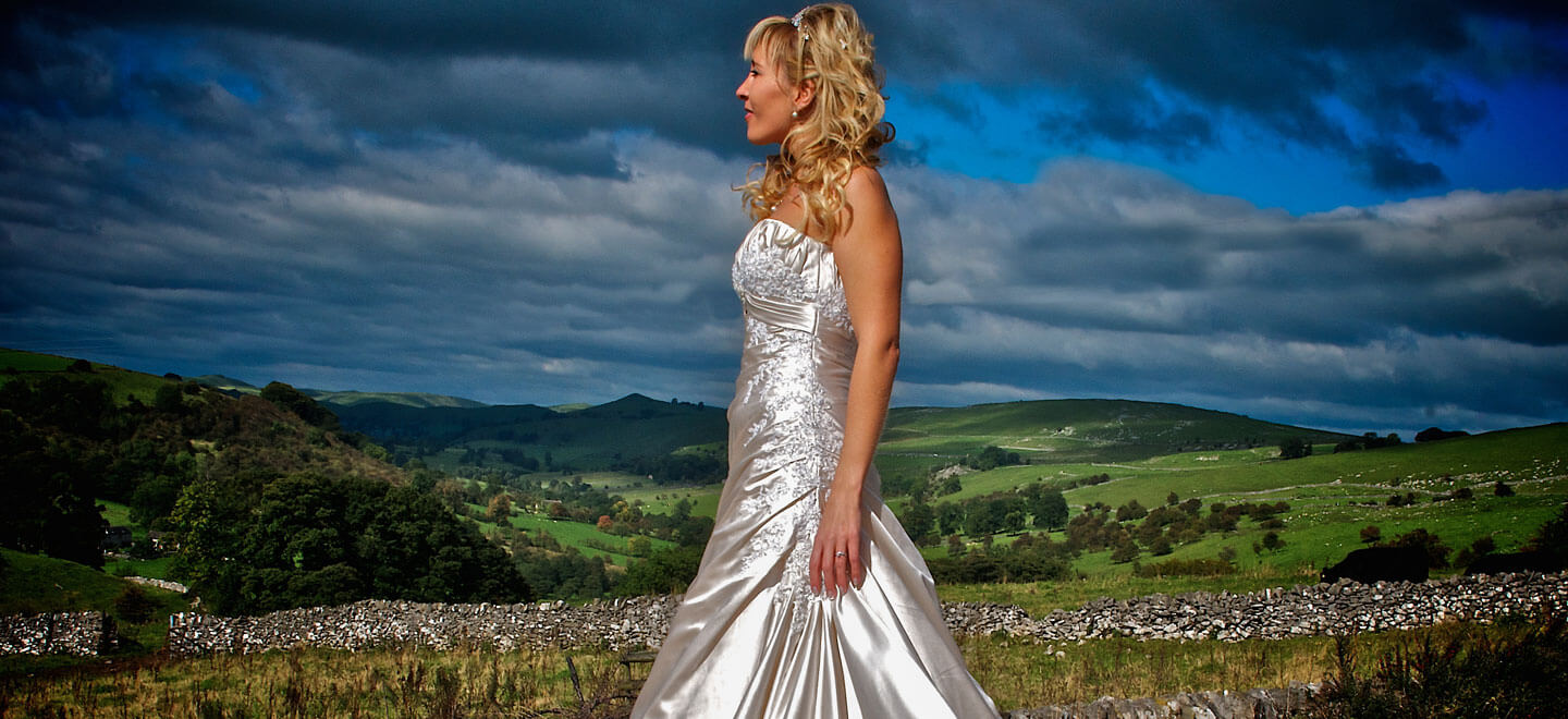 Bride overlooking countryside Image by Tony Hall Gay Wedding Photographer Derby 6