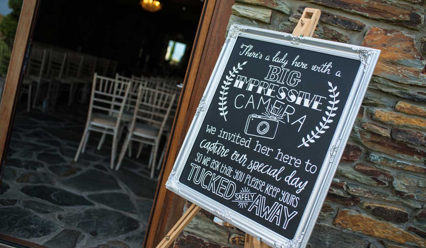Cameras away notice at lesbian wedding of emma and amy at ocean kave image by MrsJutsonPhotography 1 5