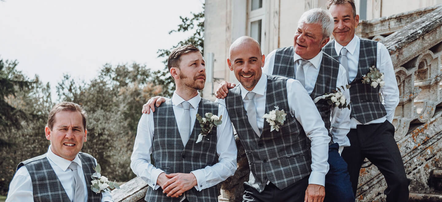 Chateau de la Valouze grooms on stairs gay destination wedding south of france 1 1