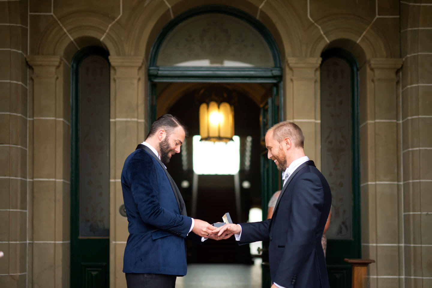 Chris and Ben exchange rings at their gay wedding gatsby themed gay wedding guide 3 5