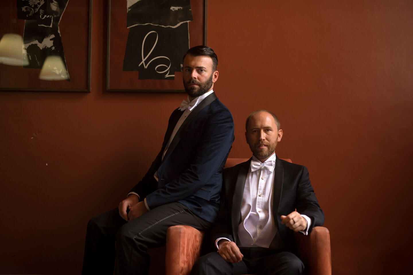 Chris and Ben post on chairs at their gay wedding gatsby themed gay wedding guide 3 5