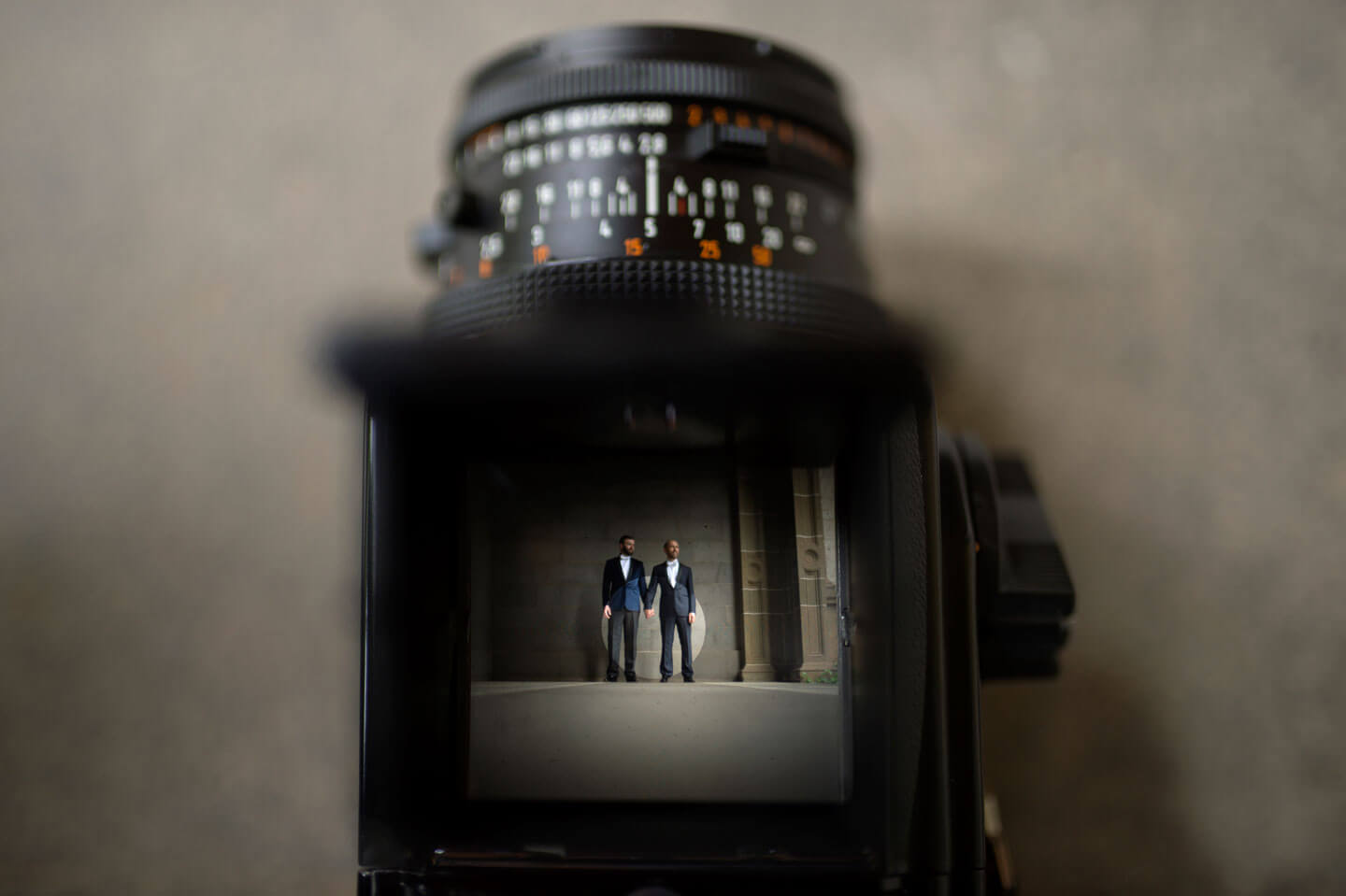 Chris and Ben through the lens of the camera at their gatsby themed gay wedding guide 3 5