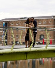 Cuddling On Bridge Over River Allison And Naomi Engagement Shoot Copyright Hazel Buckley Photography Via The Gay Wedding Guide 3 4 185X230