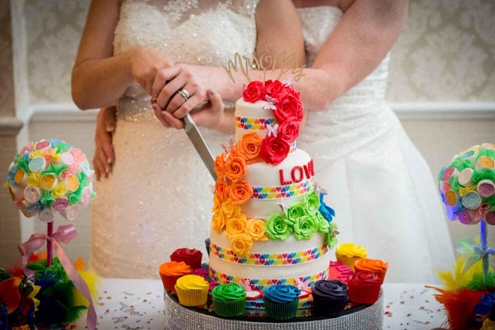 Denise Kristiana cut the cake at their real lesbian wedding image copyright Zac Photography via gay wedding guide 1 5
