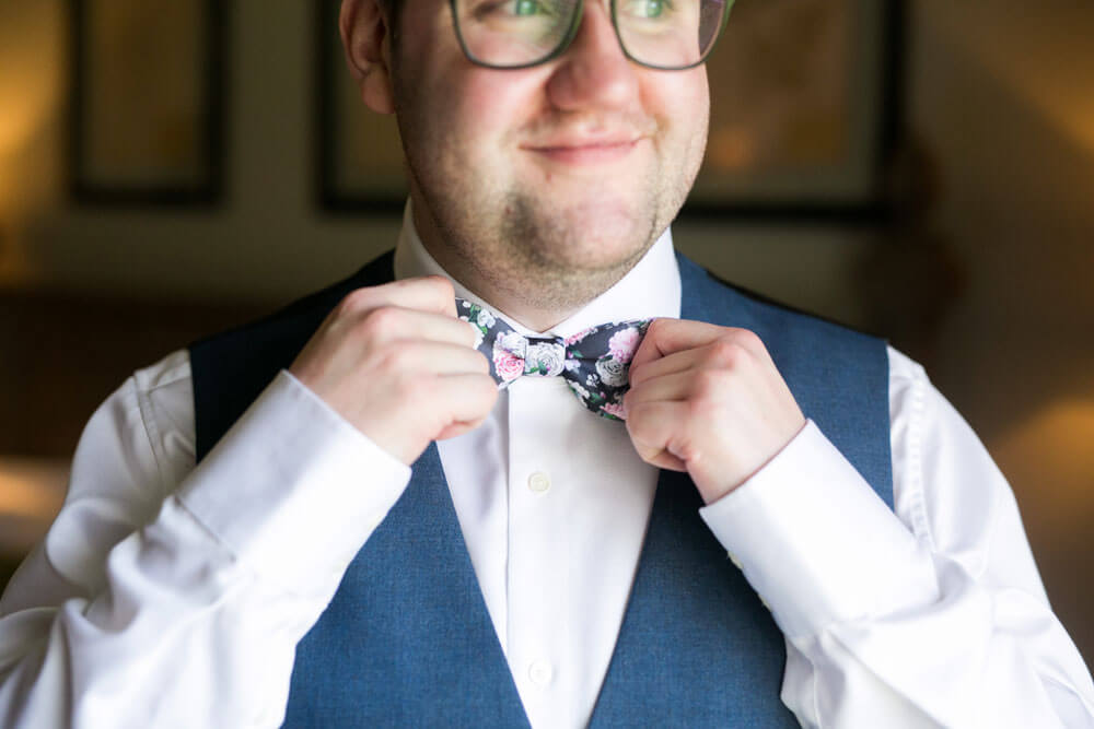 Fixing bowtie at David and Stephen real gay wedding image by Ryan Welch Photography via the Gay Wedding Guide 1 5