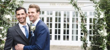Gay Grooms Hug Outside The Garden Room At Hampton Court Palace Unique Royal Wedding Venue Surrey Gay Palace Wedding Guide 9 380X174