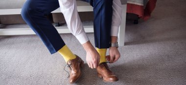 Groom Ties His Laces At Richmond Hill Hotel Surrey Wedding Venue Gay Wedding Guide 9 380X174