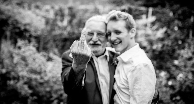 Grooms guest gives the finger image shot a manchester gay wedding by James Tracey Photography a gay wedding photographer in Manchester via the Gay Wedding Guide 3 5