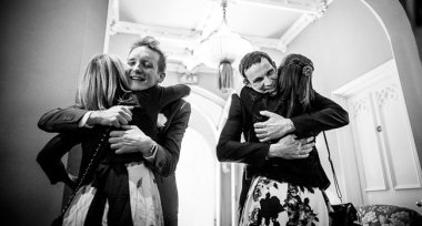 Grooms Hug Two Guests At Manchester Gay Wedding Image By James Tracey Photography A Gay Wedding Photographer In Manchester Via The Gay Wedding Guide 3 5 380X204