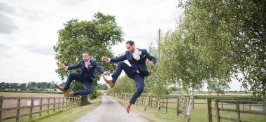 Grooms Jump In Air At Stratton Court Barn Wedding Venue Oxford Gay Wedding Guide 9 380X174