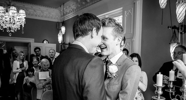 Grooms nose to nose at their manchester gay wedding image by James Tracey Photography a gay wedding photographer in Manchester via the Gay Wedding Guide 3 5