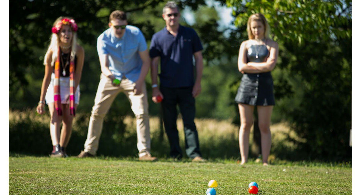 Guests playing boules at the Lesbian Wedding of Isabelle and Susie copyright Jennifer Bedlow Photography via The Gay Wedding Guide 3 5