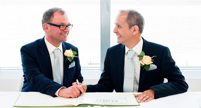 Guy and Andrew sign the register for their same sex marriage in margate photo by Webb Weddings 3 5