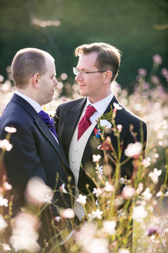 Guy and Mark in field at their gay wedding Gaynes Park image copyright Steve Hobart Photography via the gay wedding guide 1 5