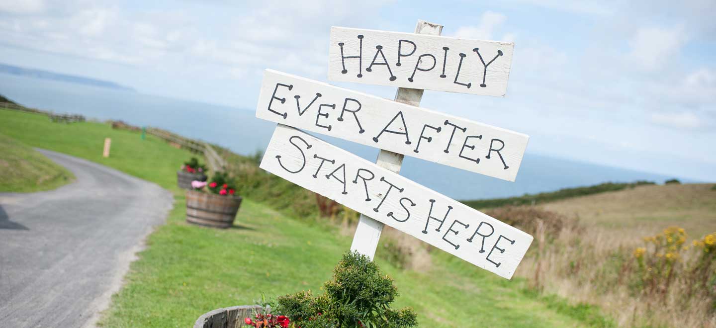 Happy ever after sign at lesbian wedding of amy at ocean kave image by MrsJutsonPhotography 1 1 5