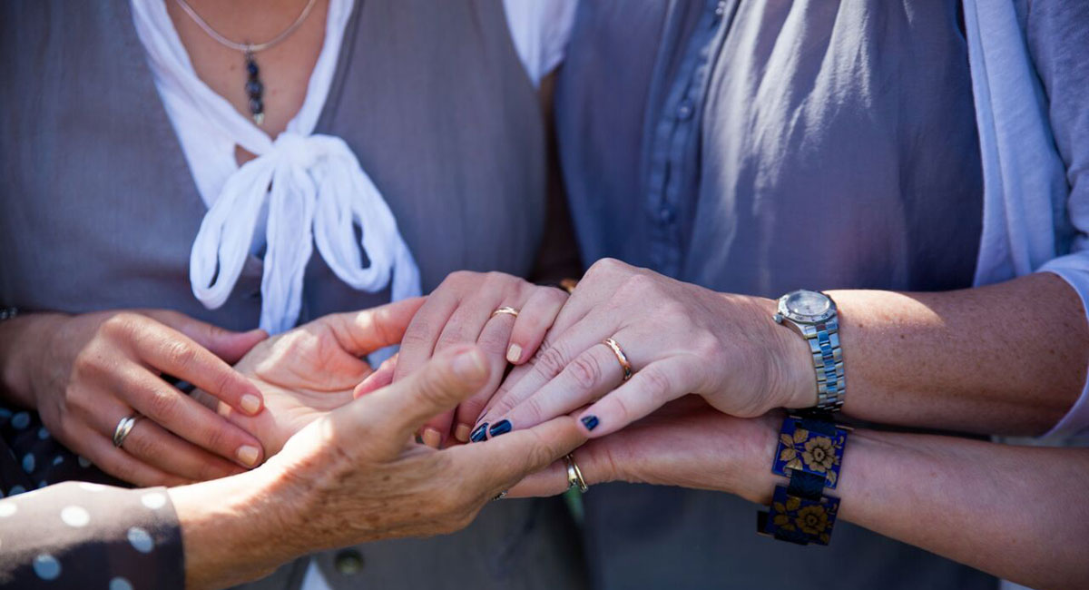 Holding hands across the generations at the Lesbian Wedding of Isabelle and Susie copyright Jennifer Bedlow Photography via The Gay Wedding Guide 3 5