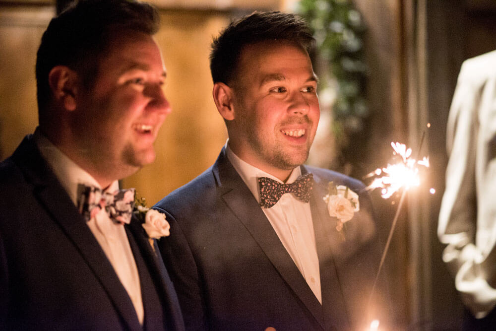Holding sparklers at David and Stephen real gay wedding image by Ryan Welch Photography via the Gay Wedding Guide 1 5