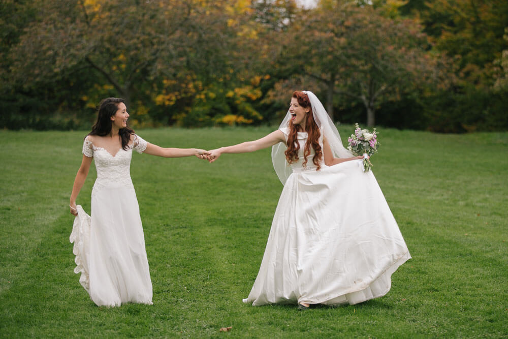 Jessie and Claudia hand in hand in field on their lesbian Wedding Shoot image copyright Rachel Movitz Weddings via the Gay Wedding Guide 1 5