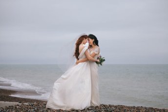 Jessie And Claudia Hug At Their 2 Brighton Beach Lesbian Wedding Shoot Image Copyright Rachel Movitz Weddings Via The Gay Wedding Guide 1 5 344X230
