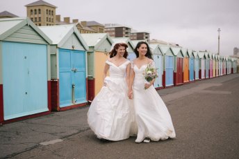 Jessie And Claudia Walk By Beach Huts Brighton Beach Lesbian Wedding Shoot Image Copyright Rachel Movitz Weddings Via The Gay Wedding Guide 1 5 344X230