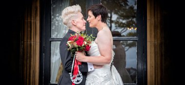 Kat And Ali Infront Of A Door At Their Lesbian Wedding Photographer This World Wedding Photography Via Gay Wedding Guide 6 380X174