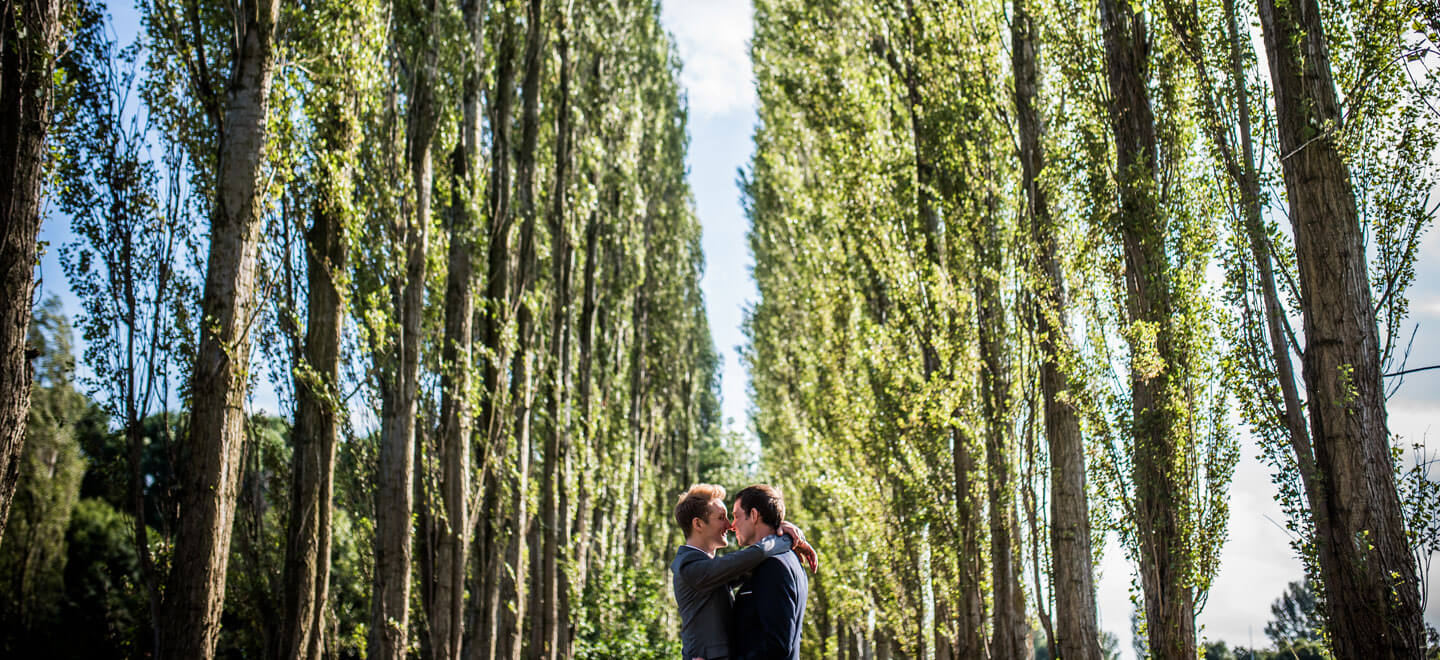 Kenny and Richard cuddling under poplar trees by James Tracey gay wedding photography via the gay wedding guide 6