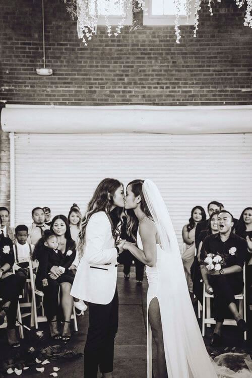 Kim and Kaycee kiss lesbian wedding photography by ruffmedia via the gaywedding guide 1 5