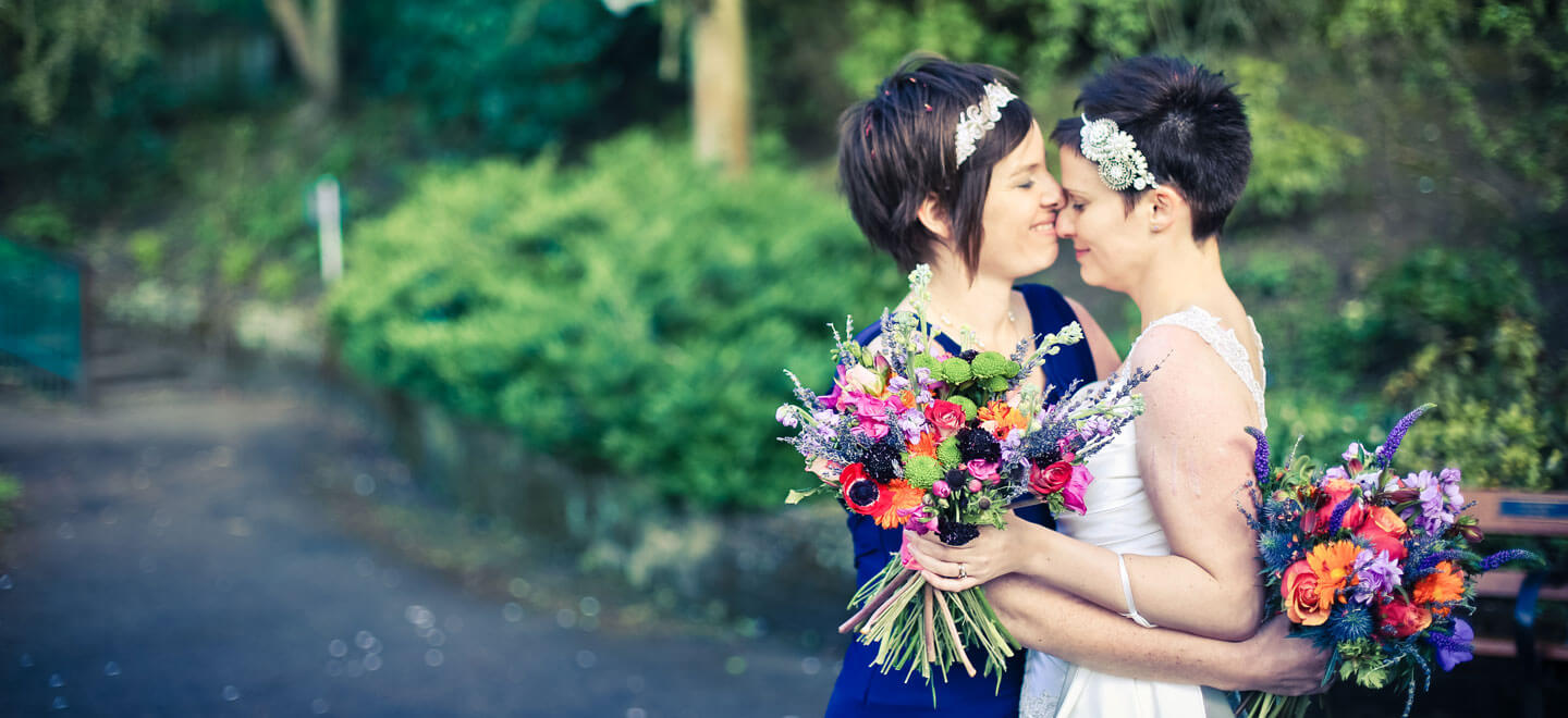 Lesbian Brides spring wedding cuddle by Lesbian wedding photography Daria Nova Photography via Gay Wedding Guide 6