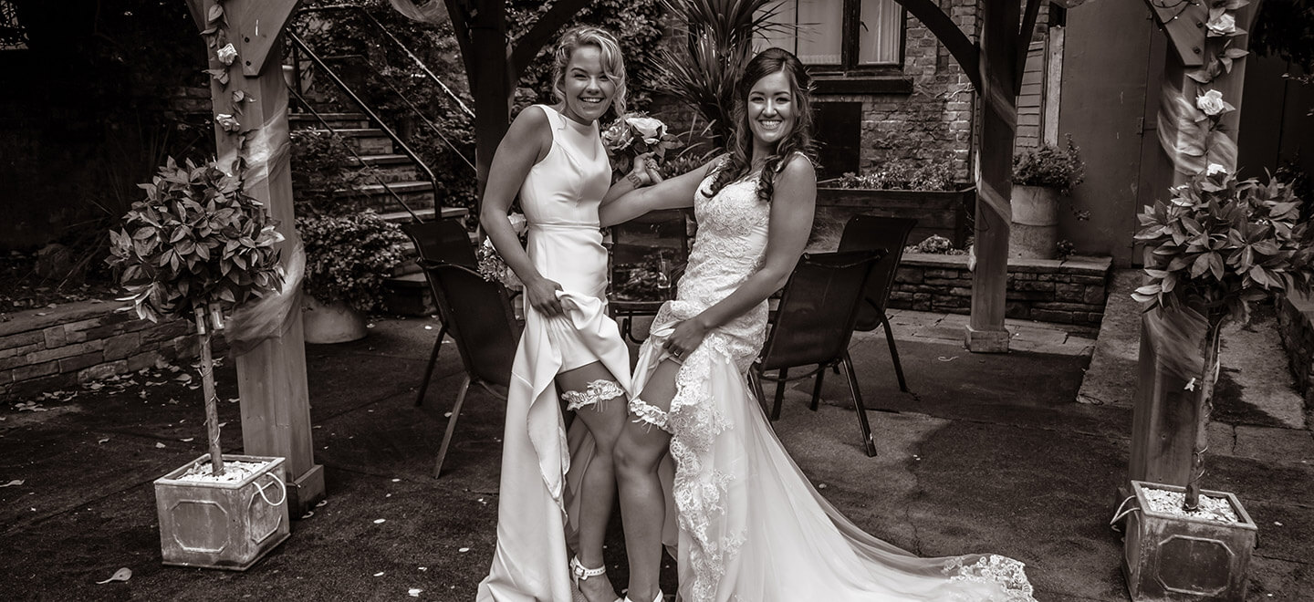 Lesbian brides show garters photograph by Paul Walker Photographer Gay Wedding Guide 6