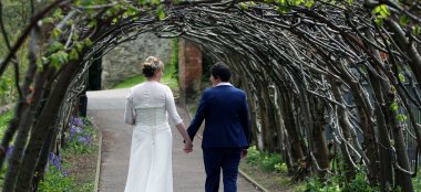 Lesbian Brides Walk Under Branch Arch At The Kings Arms Dorset Wedding Venue Gay Wedding Guide 9 380X174