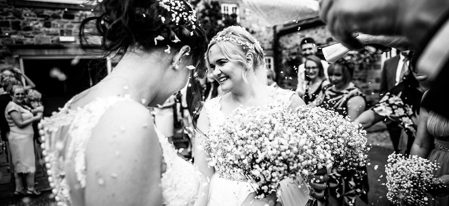 Lesbian brides with confetti photograph by Paul Walker Photographer Gay Wedding Guide 6