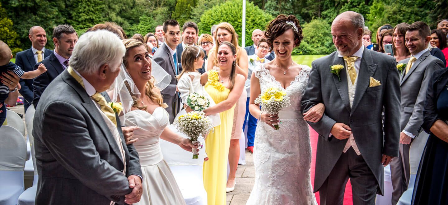 Lynsey and Joanne walking down the aisle by James Tracey gay wedding photography via the gay wedding guide 6