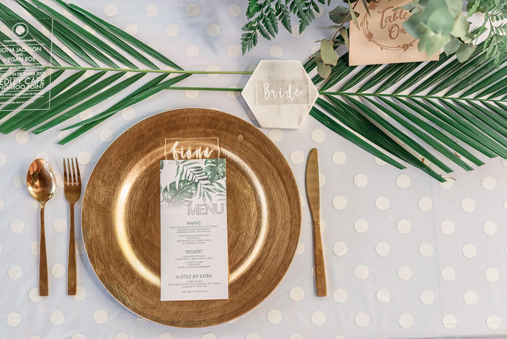Megan and Fiona gold and banana leaf place setting at their lesbian wedding australia shoot via Brisbane City Celebrants Elysia and the gay wedding guide 8