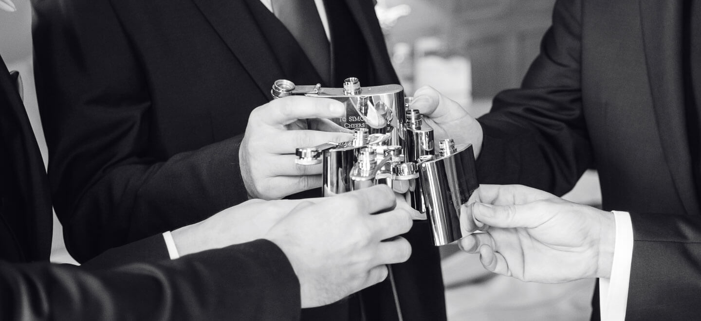 Men toast with hipflasks at Richmond Hill Hotel Surrey Wedding Venue Gay Wedding Guide 9