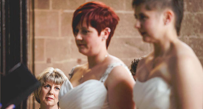 Mother gazes as Michelle and Rachel say their vows shot by Ragdoll Photography via The Gay Wedding Guide 3 5